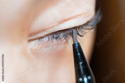 Close-Up of a Woman Applying Eyeliner to Their Eyelid
