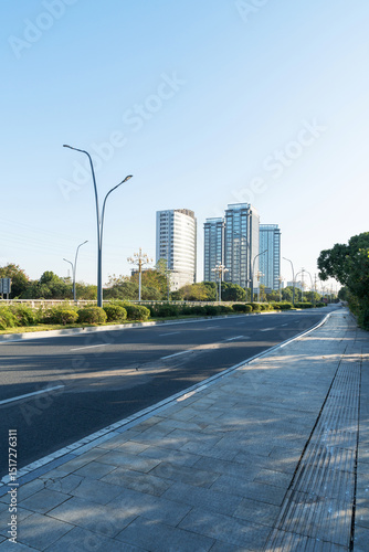 Fototapeta Naklejka Na Ścianę i Meble -  Empty urban road and buildings in the city