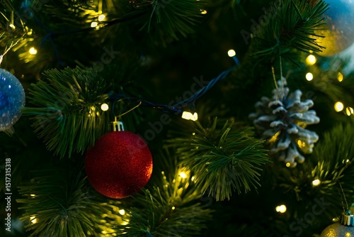 Festive Christmas Tree Close-Up with Glowing Lights and Colorful Baubles on Holiday Eve photo