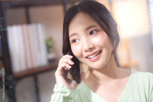 Konstfotografi Young asian businesswoman telephone smiling and relax in living room at home office, cheerful woman standing talking with smart phone in home, expression and emotion, business and communication
