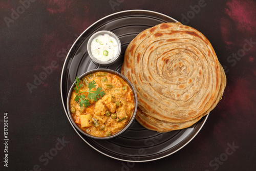 Malabar parotta with Kurma is a delicacy from the state of Kerala, Tamilnadu. Kurma is mixed veg south Indian curry with coconut milk