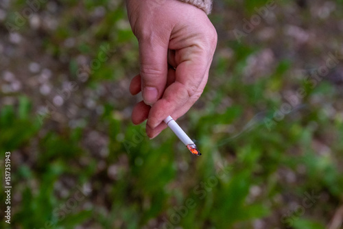 Wallpaper Mural Hand holding a cigarette. Addiction concept. High quality photo Torontodigital.ca