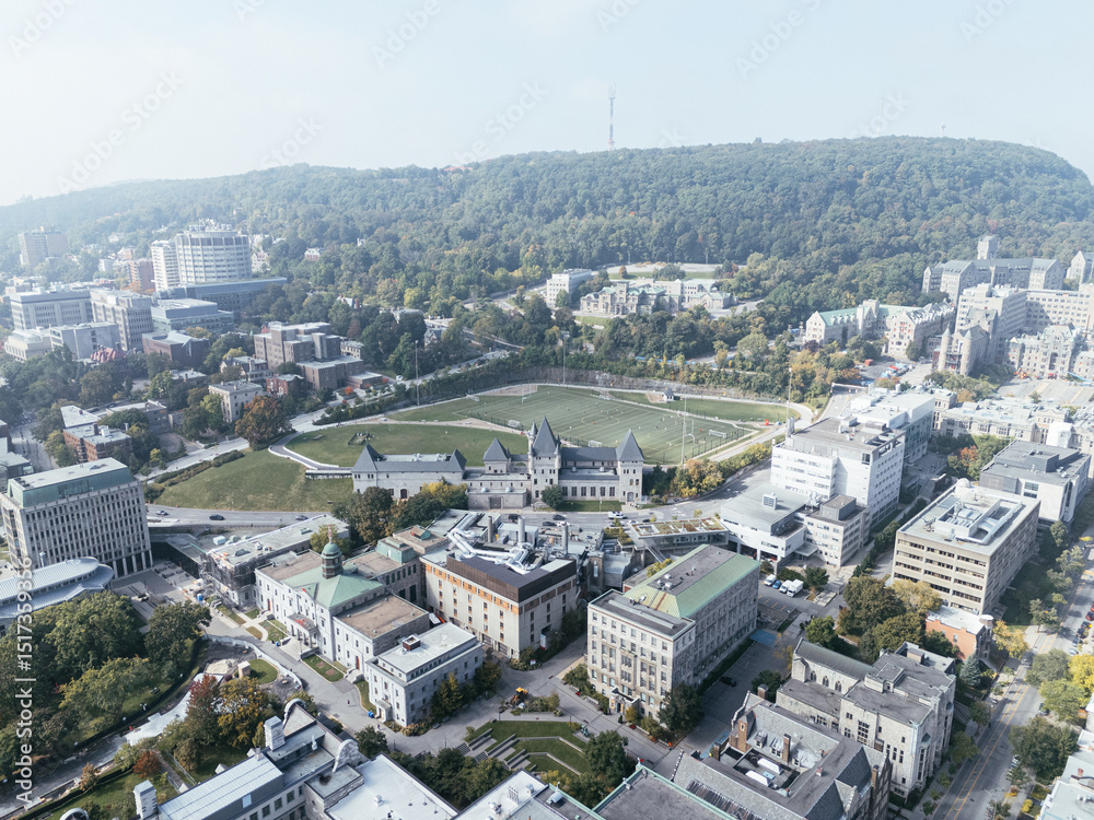 Fototapeta premium Drone flight in the downtown city skyline, foggy daytime view of Montreal, Quebec, Canada