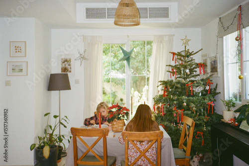 Two girls having breakfast on Christmas holidays in a warm country