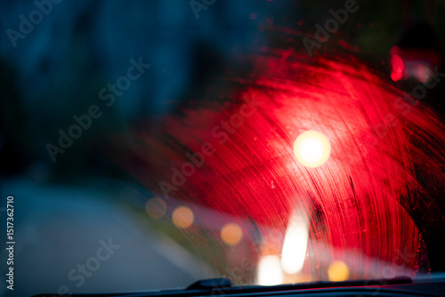Car windshield texture with blurred traffic light