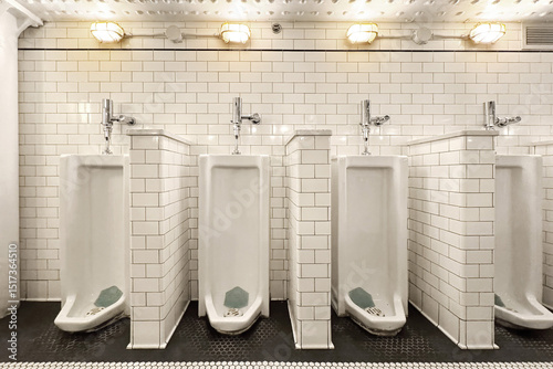 Urinals in public restroom photo