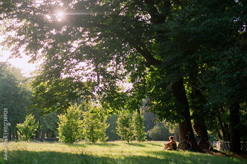 Woman sitting under big tree  photo