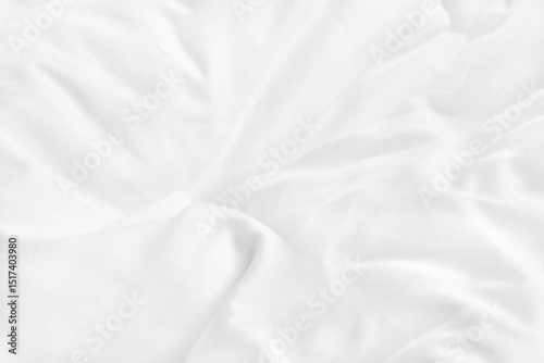 Close up top view of white bedding sheet and wrinkle messy blanket in bedroom after wake up in the morning.