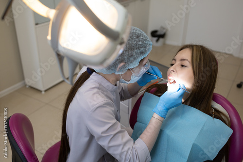 The dentist examines the patient's oral cavity. teeth