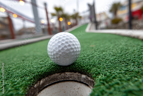 Minigolf - putt for the last few inches to hole photo