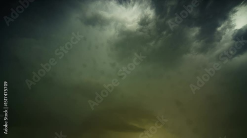 Dramatic time-lapse of dark storm clouds moving across the sky during sunset with a hint of blue sky