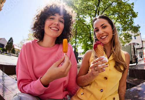Women are enjoying ice creams outside