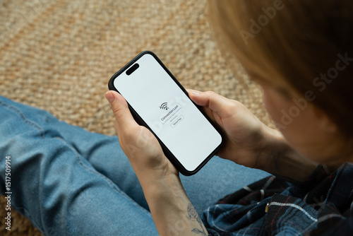 Woman having problem with wifi connection on mobile phone photo
