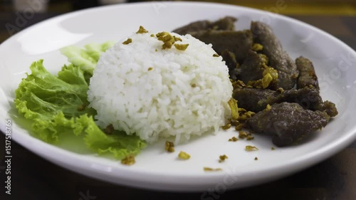 Fried Pork With Rice On A White Plate, Video footage for documentary and cinematic in food scene.