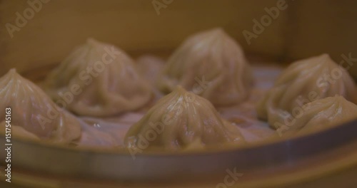 Wallpaper Mural Xiao long bao in the steamer basket at dinner close up handheld shot Torontodigital.ca