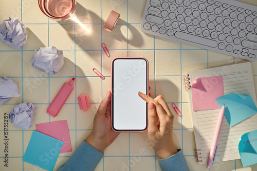 Top view shot of hands touching the screen of a mobile phone photo