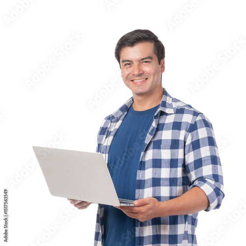 Handsome young man smiling while holding laptop computer, wearing blue checkered shirt, isolated on a transparent background, casual freelancer or student working online, remote work lifestyle concept