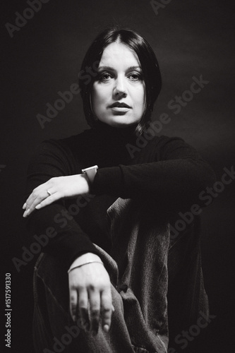 Portrait of a woman with dark hair, done in low key style.