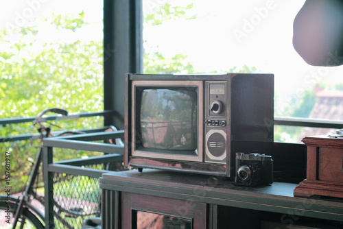 an old tv and retro camera on a rack, with copy space that perfect for illustration