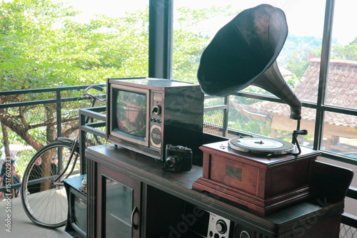 Perfect illustration for retro background style, with old tv, retro camera, gramophone on a desk beside old bycicle.