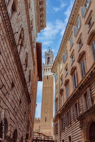 Fototapeta Naklejka Na Ścianę i Meble -  The historic streets of Siena are a showcase of medieval architecture and cozy, cobbled pathways. Located in the region of Tuscany in Italy, this city provides a unique experience for visitors.