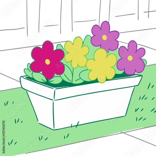 Colorful flowers blooming in a white planter on green grass  