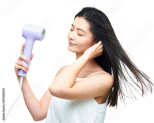 Asian girl using hair dryer