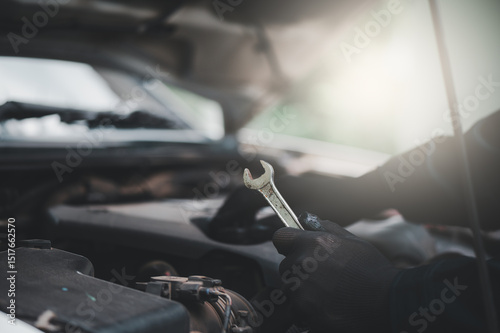 Auto mechanic working in a garage. Auto mechanic technician working in a garage. Service and maintenance. Car inspection.