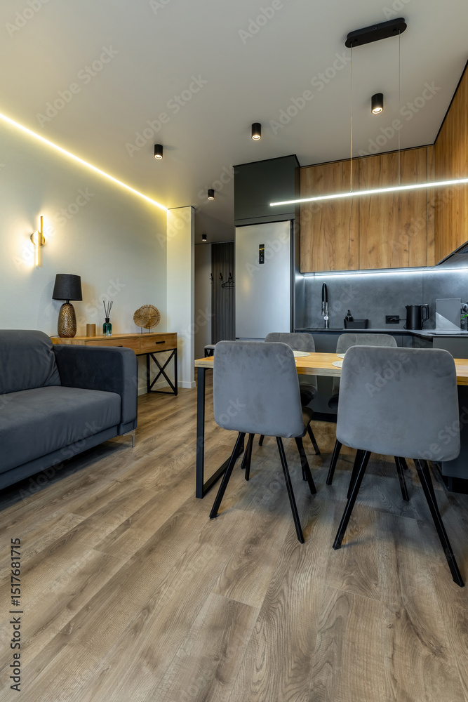 Obraz premium Open-Plan Kitchen and Living Room with Cozy Lighting