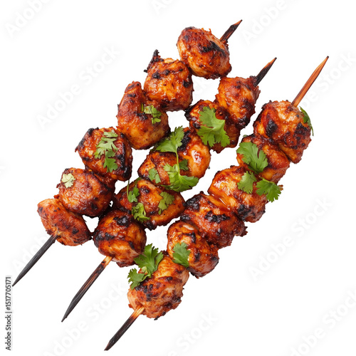 Spicy grilled chicken tikka on skewers with garnish, isolated on white background, Indian street food 

