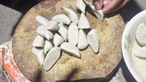 Asian cook is cooking in thai kitchen in local traditional country style, preparing fresh fish balls to cook thai food green curry popular worldwide