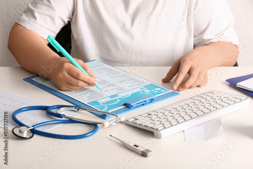 Female doctor filling out l...