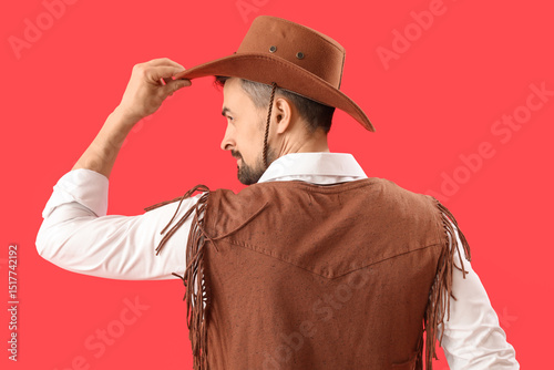 Handsome cowboy on red back...
