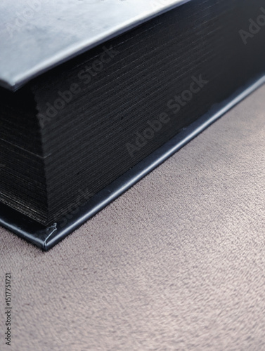 close-up of a thick book with black-edged pages