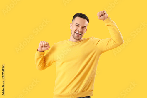 Happy young man on yellow b...