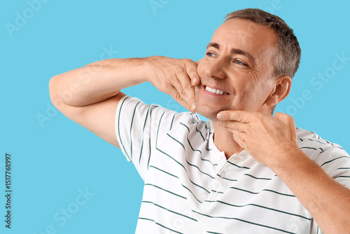 Happy mature man doing face...