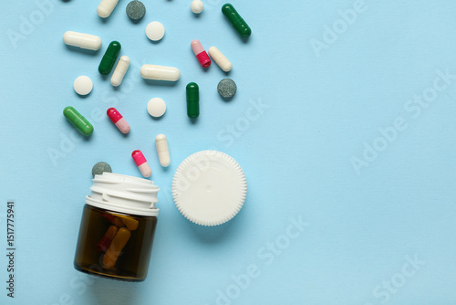Bottle with scattered pills...
