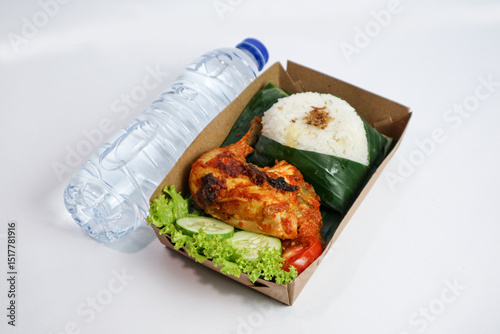 Grilled Chicken with rice,Nasi Ayam Bakar Lalapan,Authentic recipe of Indonesian chicken and mineral water