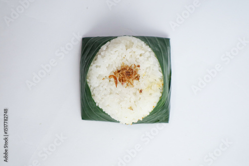 Indonesian food culinary steamed White rice with sprinkle of fried shallots plating with banana leaf