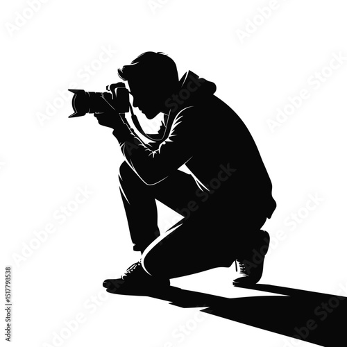 Silhouette of a photographer kneeling capturing a moment in black and white against a clean white background