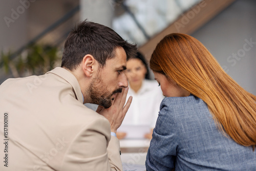 Businesspeople gossiping during the meeting at corporate firm.