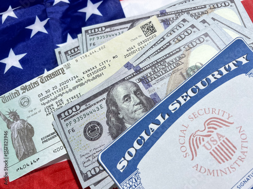 Social security card, us treasury check and currency bills on the American flag in the backdrop. U.S. citizen, benefits, ssn, funds