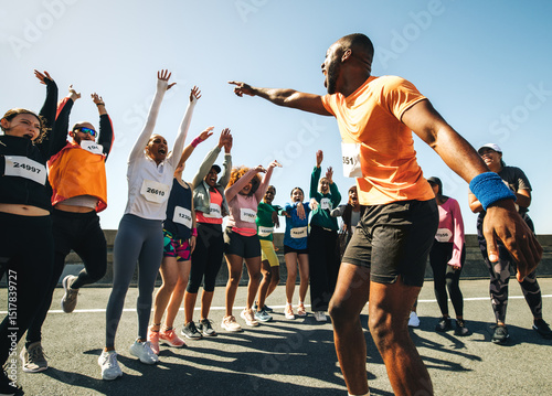 Fototapeta Naklejka Na Ścianę i Meble -  Dynamic running club with coach energizing the group