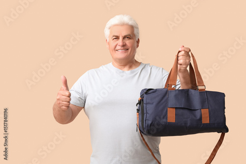 Senior man with sports bag ...