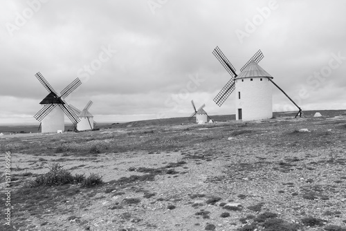 a group of white wind mill in rural landscape