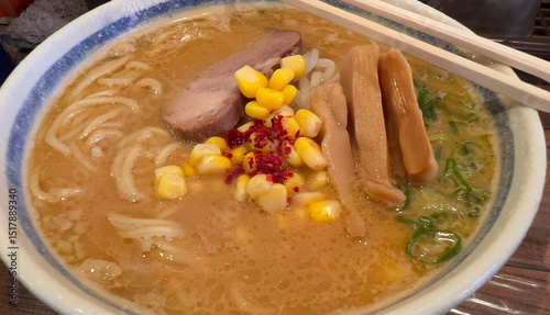 Tonkotsu Ramen with Corn, Chashu, and Bamboo Shoots in a Large White Bowl, Traditional Japanese Comfort Food