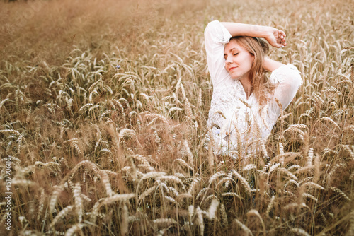 girl in a wheat field in the hot summer