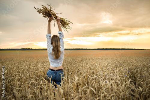 girl in a wheat field in the hot summer