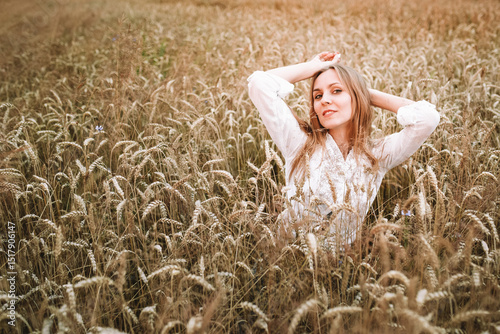 girl in a wheat field in the hot summer