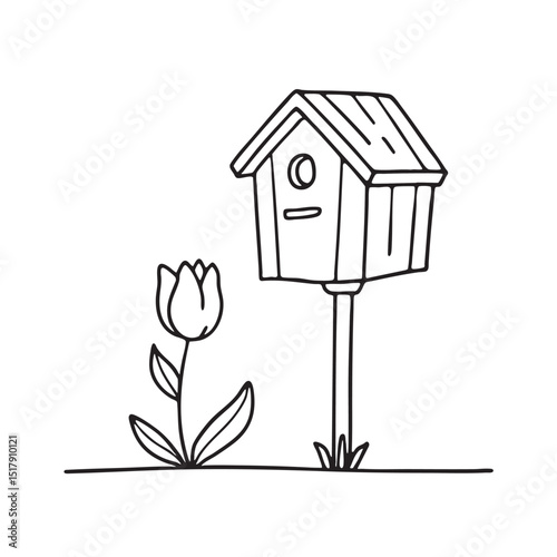 A tulip growing below a birdhouse post